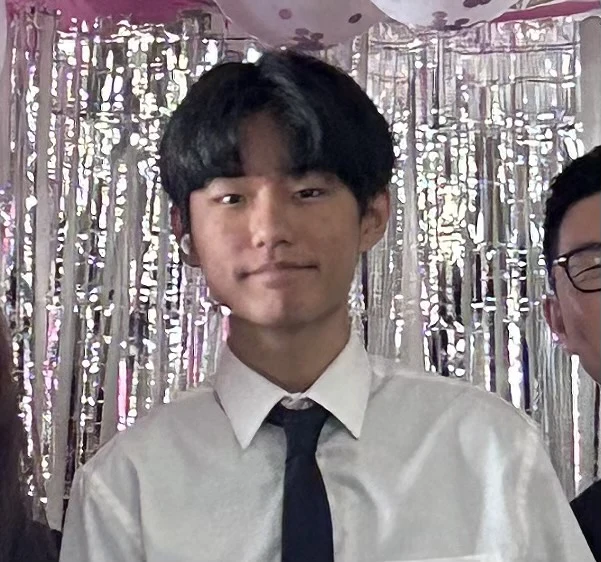 Brandon Baek in a white shirt and tie